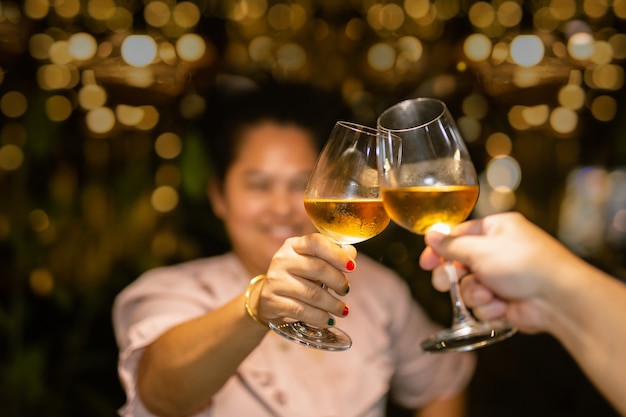 Couple clinking glass of white wine for celebration