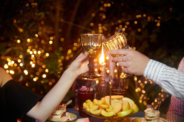 Couple clinking glasses of champagne at romantic dinner in restaurant closeup