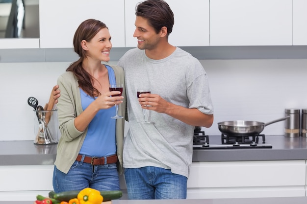 Couple clinking their glasses of red wine