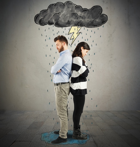 Couple under cloud with lightning and rain