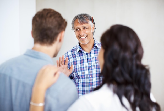 Couple consulting male architect Mature engineer discussing home renovation plan with couple