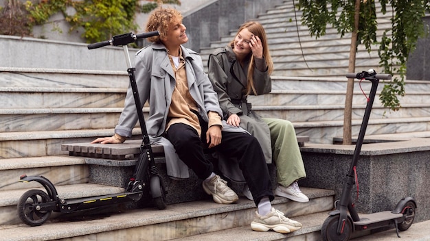 Couple conversing next to electric scooters