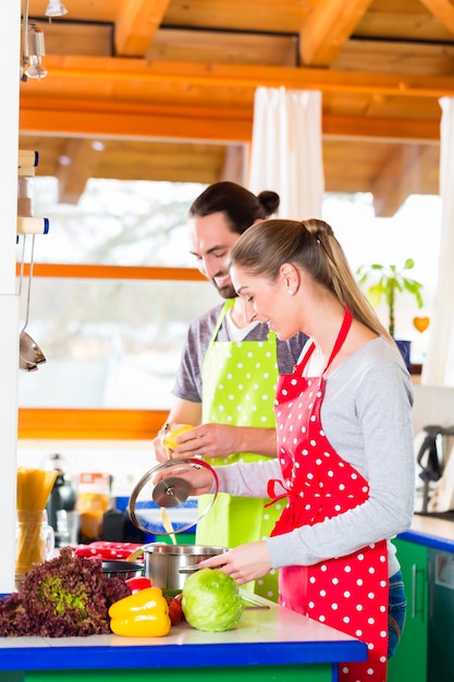 Couple cooking in domestic kitchen healthy food