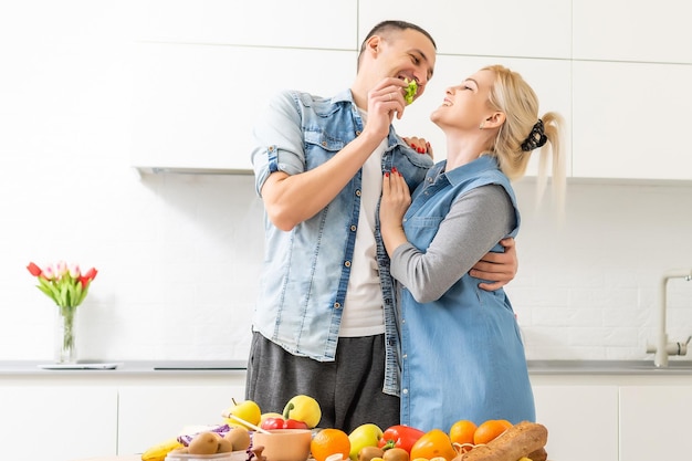 couple cooking healthy food in kitchen lifestyle meal preparation.