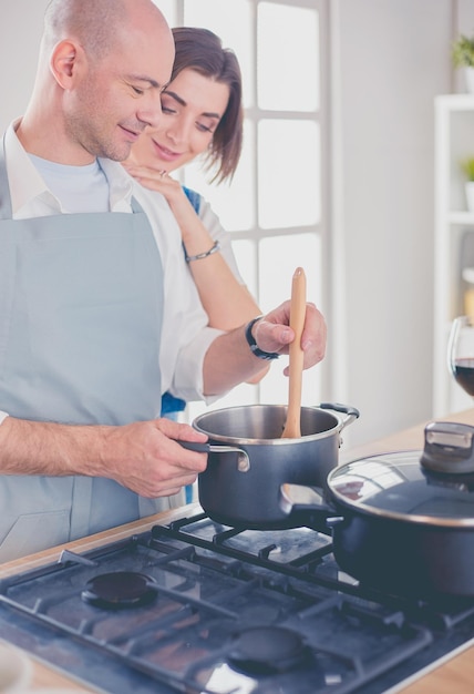 Couple cooking together in the kitchen at home