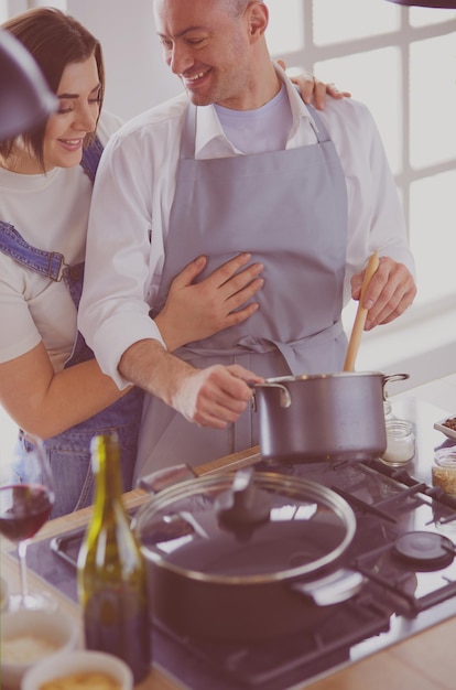 Couple cooking together in the kitchen at home