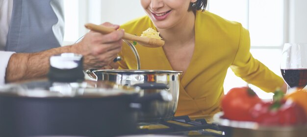 Couple cooking together in the kitchen at home