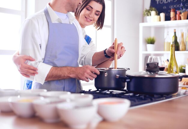 Couple cooking together in the kitchen at home