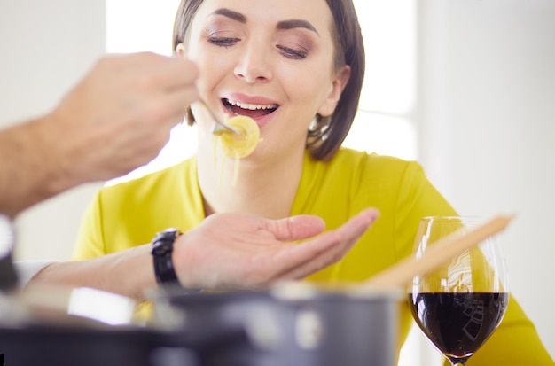 Couple cooking together in the kitchen at home