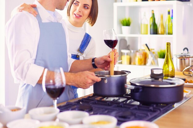 Couple cooking together in the kitchen at home