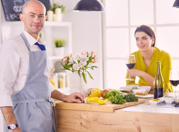 Couple cooking together in the kitchen at home