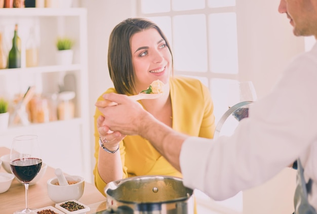 Couple cooking together in the kitchen at home