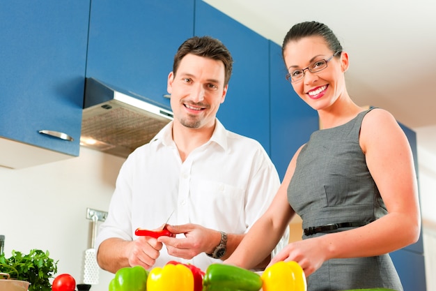 Couple cooking together in kitchen