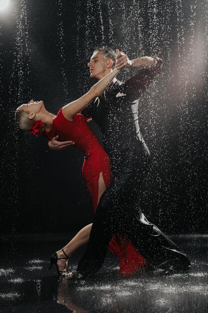 A couple of dancers on a black background in a studio in the aqua zone