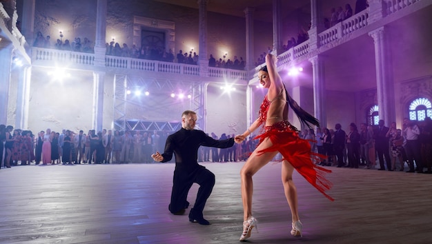 Couple dancers perform latin dance on large professional stage Ballroom dancing