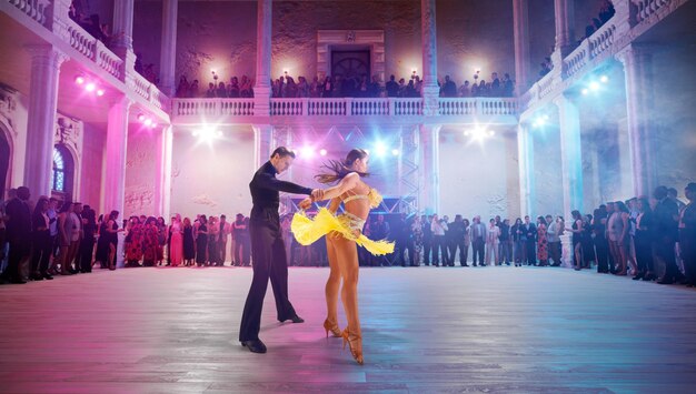 Couple dancers perform latin dance on large professional stage Ballroom dancing