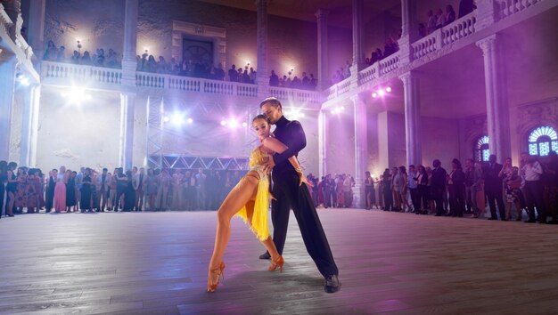 Couple dancers perform latin dance on large professional stage Ballroom dancing