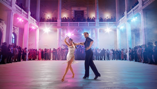 Couple dancers perform latin dance on large professional stage Ballroom dancing