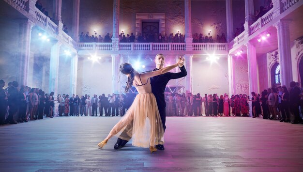 Couple dancers perform waltz on large professional stage\
ballroom dancing