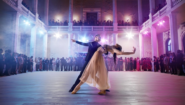 Couple dancers perform waltz on large professional stage Ballroom dancing