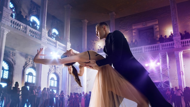 Couple dancers perform waltz on large professional stage Ballroom dancing