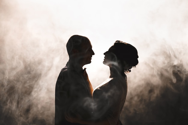 Couple dancing with white smoke background