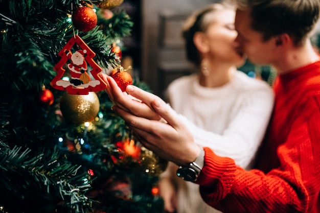 Couple decorating christmas tree