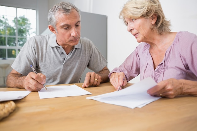 Couple discussing with documents