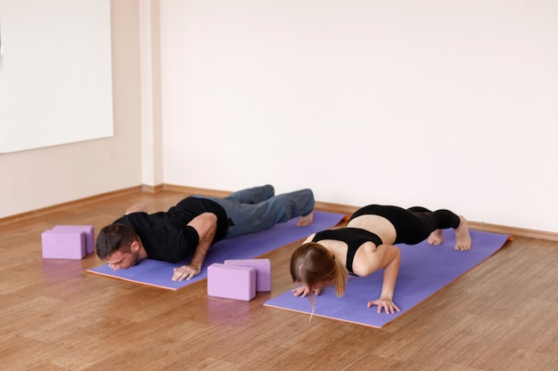 The couple does yoga in the studio. healthy lifestyle