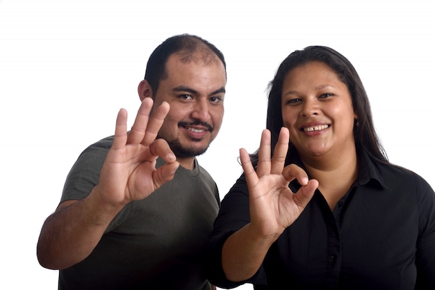 Couple doing the ok sign on white 