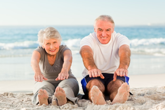 Couple doing their streches at the beach