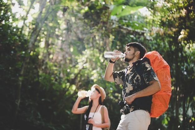 Couple Drink Water In The Forest 