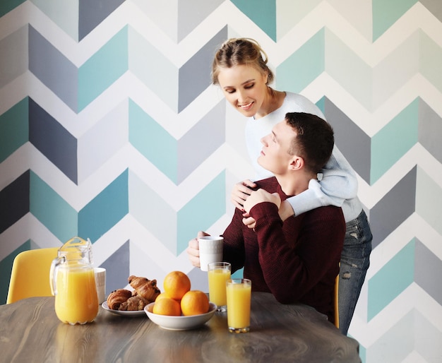 Couple eating breakfast early in the morning in the kitchen