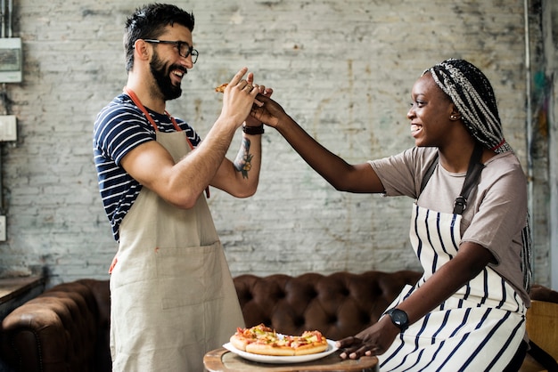 A couple eating pizza together