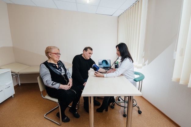 A couple of elderly people are conducting a medical examination at a medical center. Medicine and healthcare