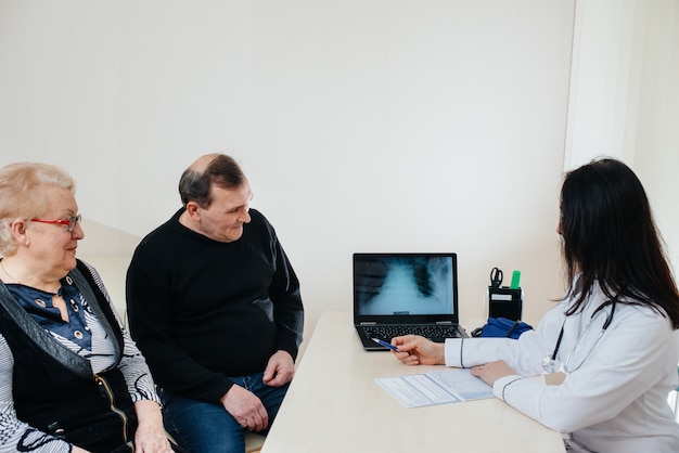 A couple of elderly people at a personal doctor's appointment at a medical center. Medicine and healthcare