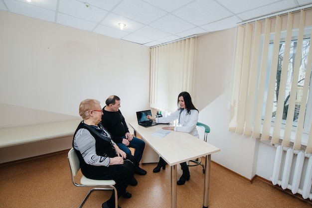 A couple of elderly people at a personal doctor's appointment at a medical center. Medicine and healthcare.