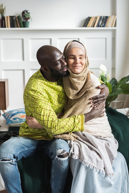 Couple embracing on bed at home