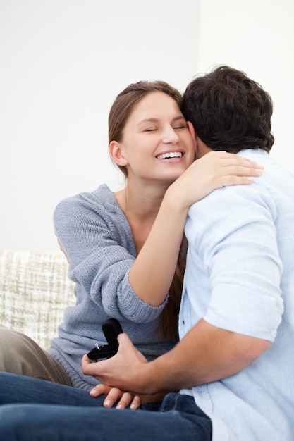 Couple embracing eachother while holding a jewel case 