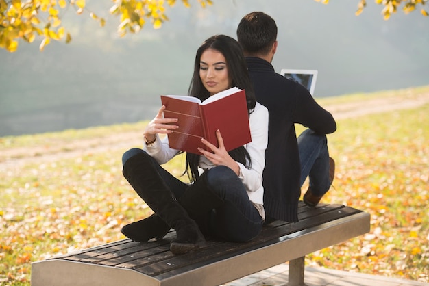 Couple Enjoying Digtial Tablet And Book