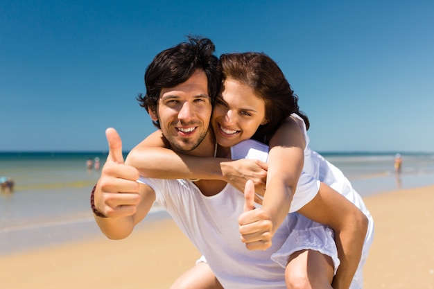 Couple enjoying freedom on the beach