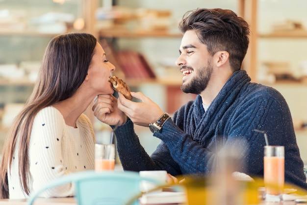 Couple enjoying meal sitting at cafe table