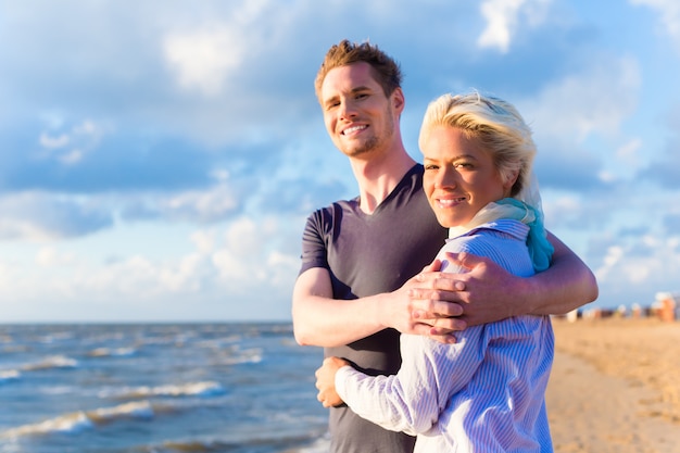 Couple enjoying romantic sunset on beach