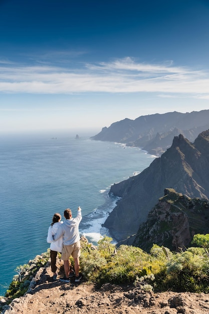 Couple enjoying vacation in nature Hikers watching beautiful coastal scenery