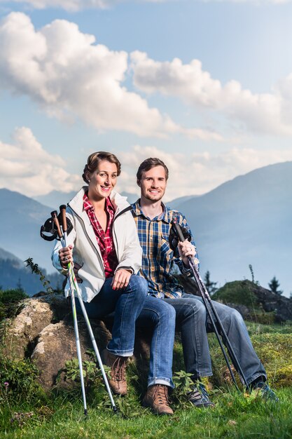 Couple enjoying view hiking in the alpine mountains