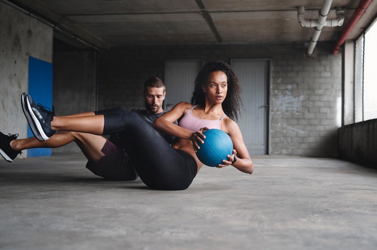 Photo couple exercise and fitness with medicine ball outdoor for workout balance training and core strength of performance active people and muscle challenge strong biceps and support for gym results