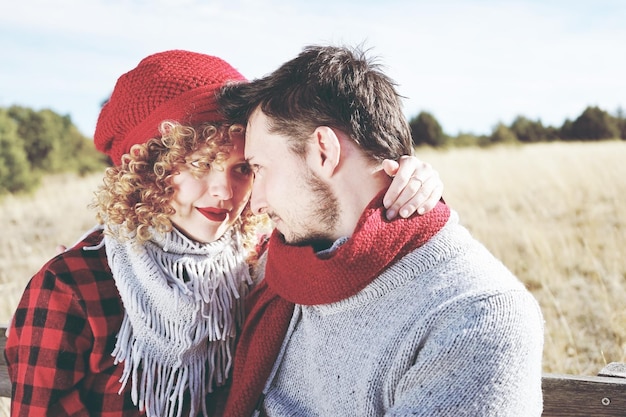 couple face to face sitting on bench