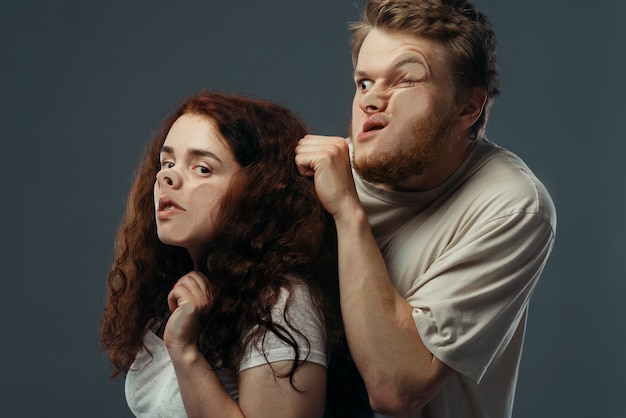 Couple faces crushed on glass, funny emotion