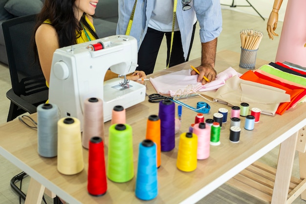 couple fashion designers are discussing and designing their stylish cloth for new clothes collection