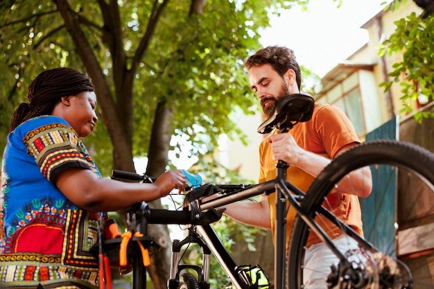 Photo couple fastening bicycle for repair